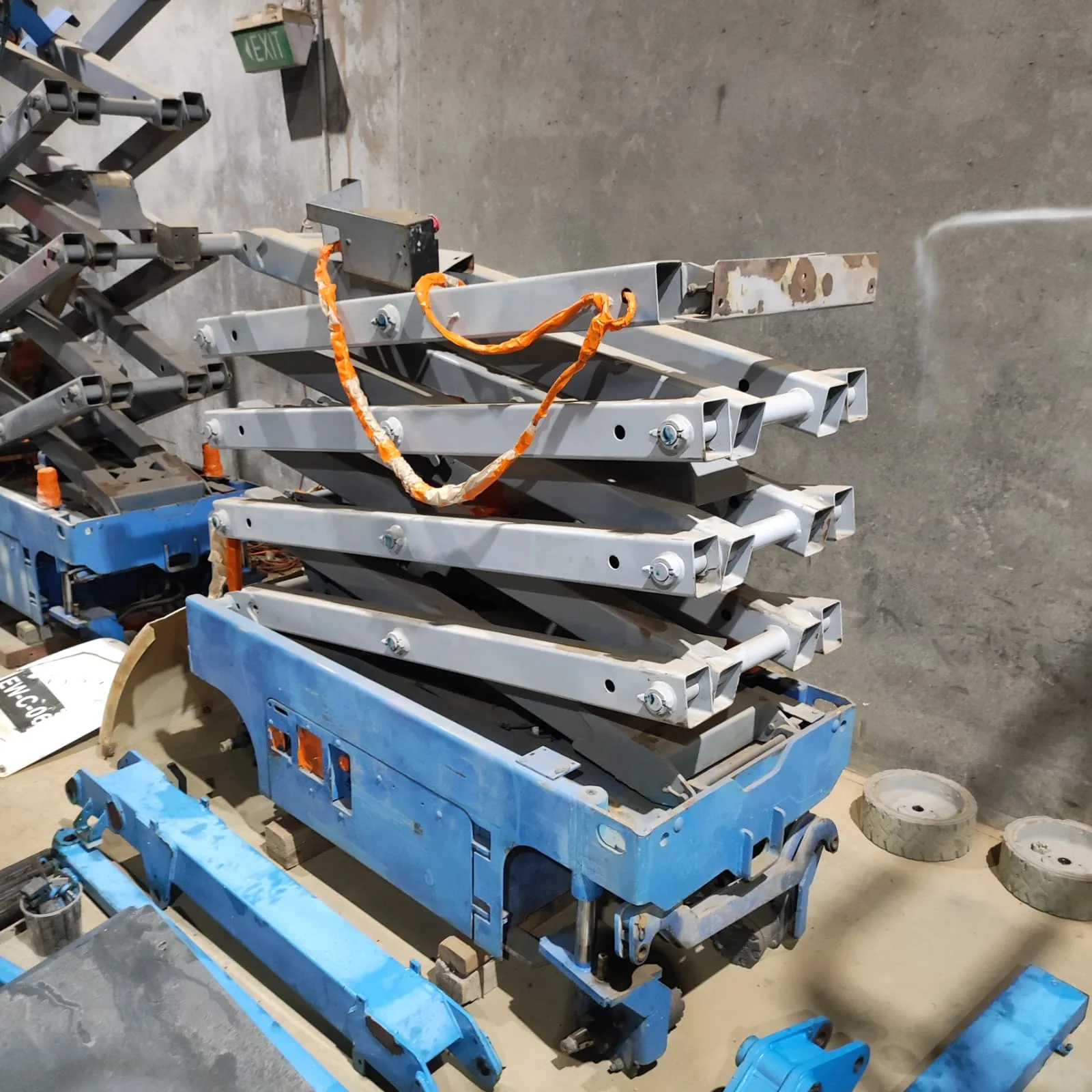 Disassembled scissor lift mechanism in the workshop