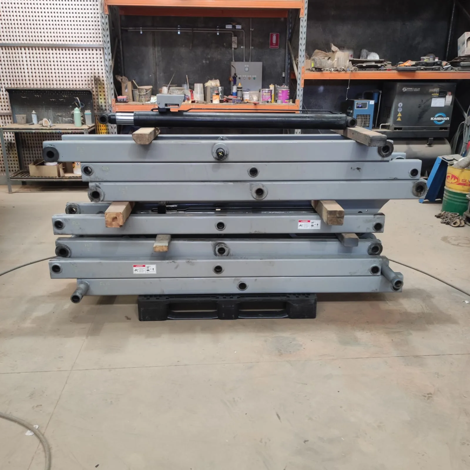 Scissor arms stripped for full structural and pin inspection