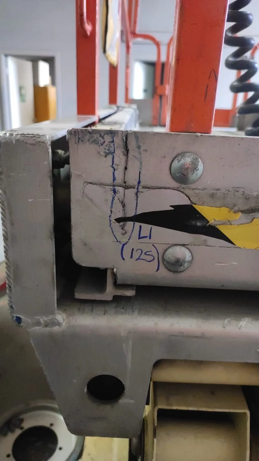 Crack flagged on scissor rail (measured and marked for repair)
